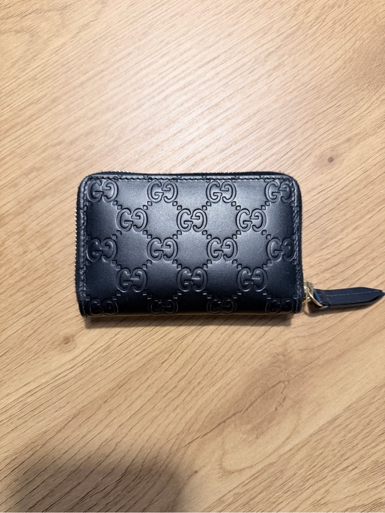 Gucci Accessories - Gucci Black GG Embossed Leather Zip wallet